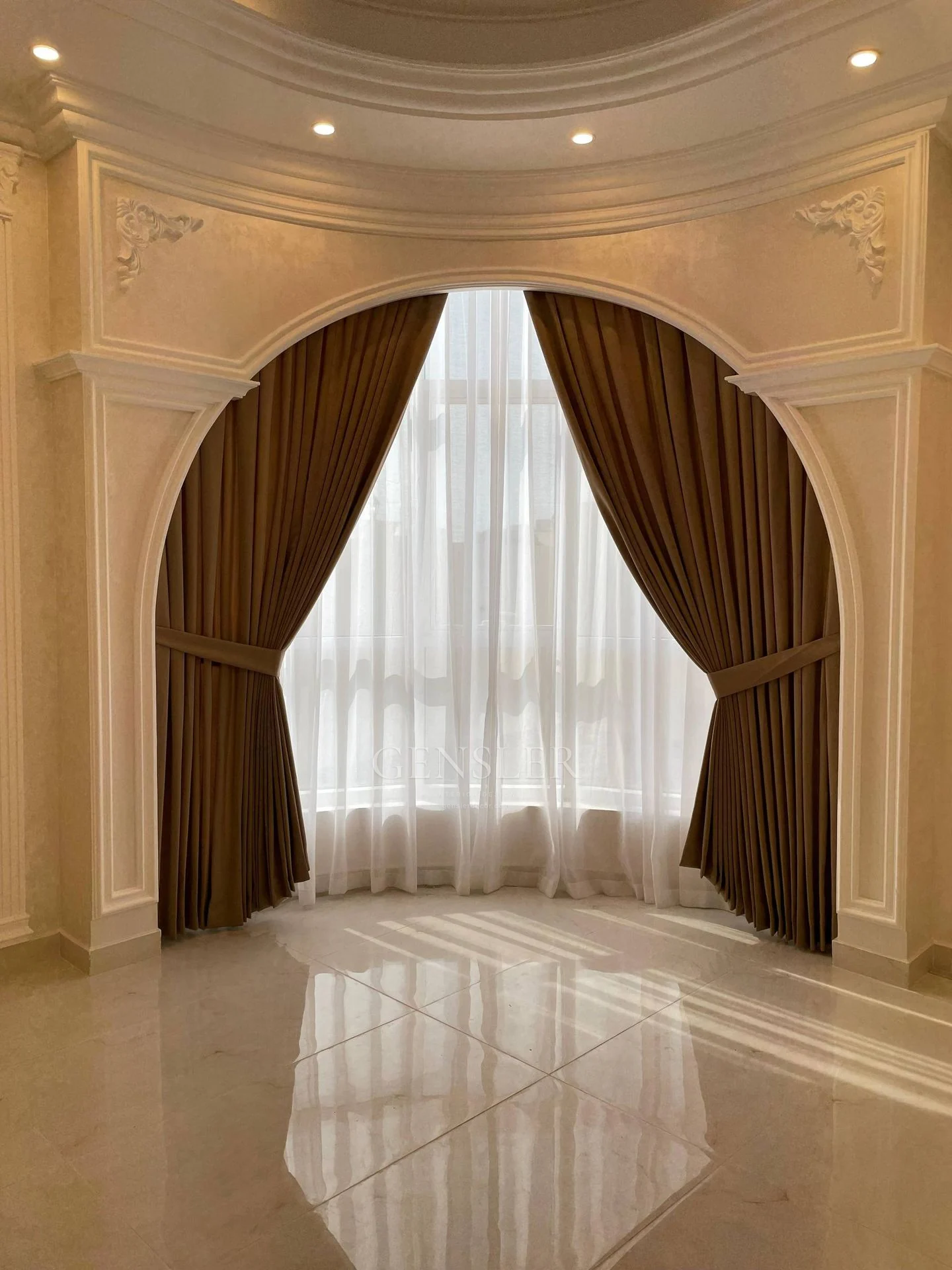 Brown side curtains framing an arched opening with white sheers.