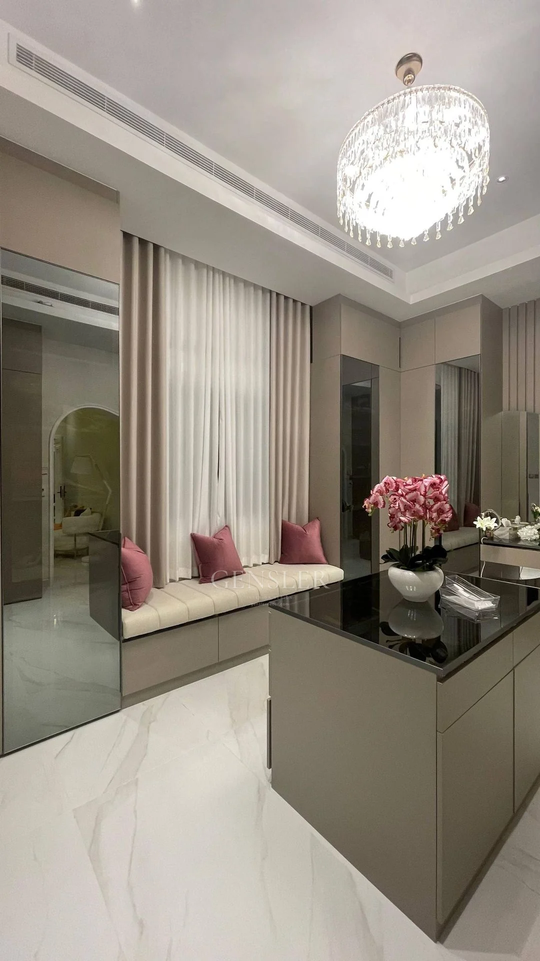 Neutral curtain panels beside a mirrored dressing area.