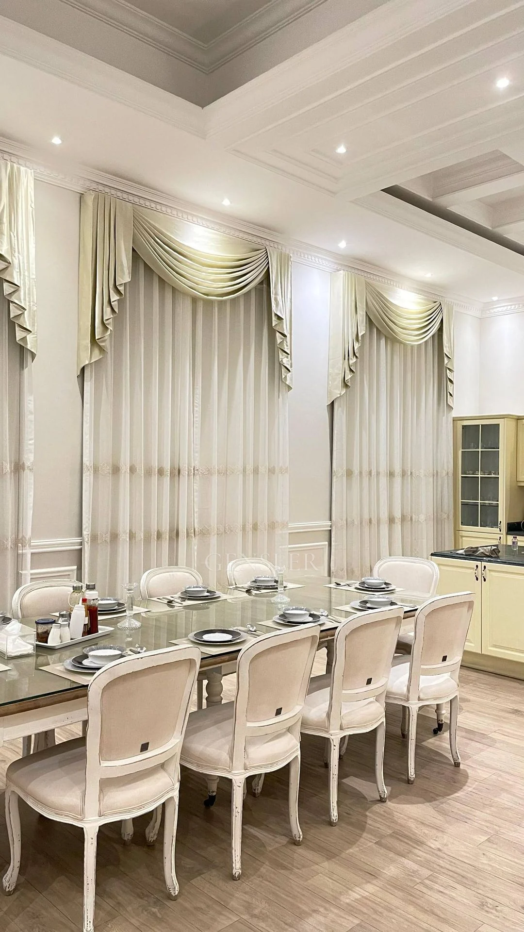 Wide portrait view of the classical dining setting and gathered curtains.