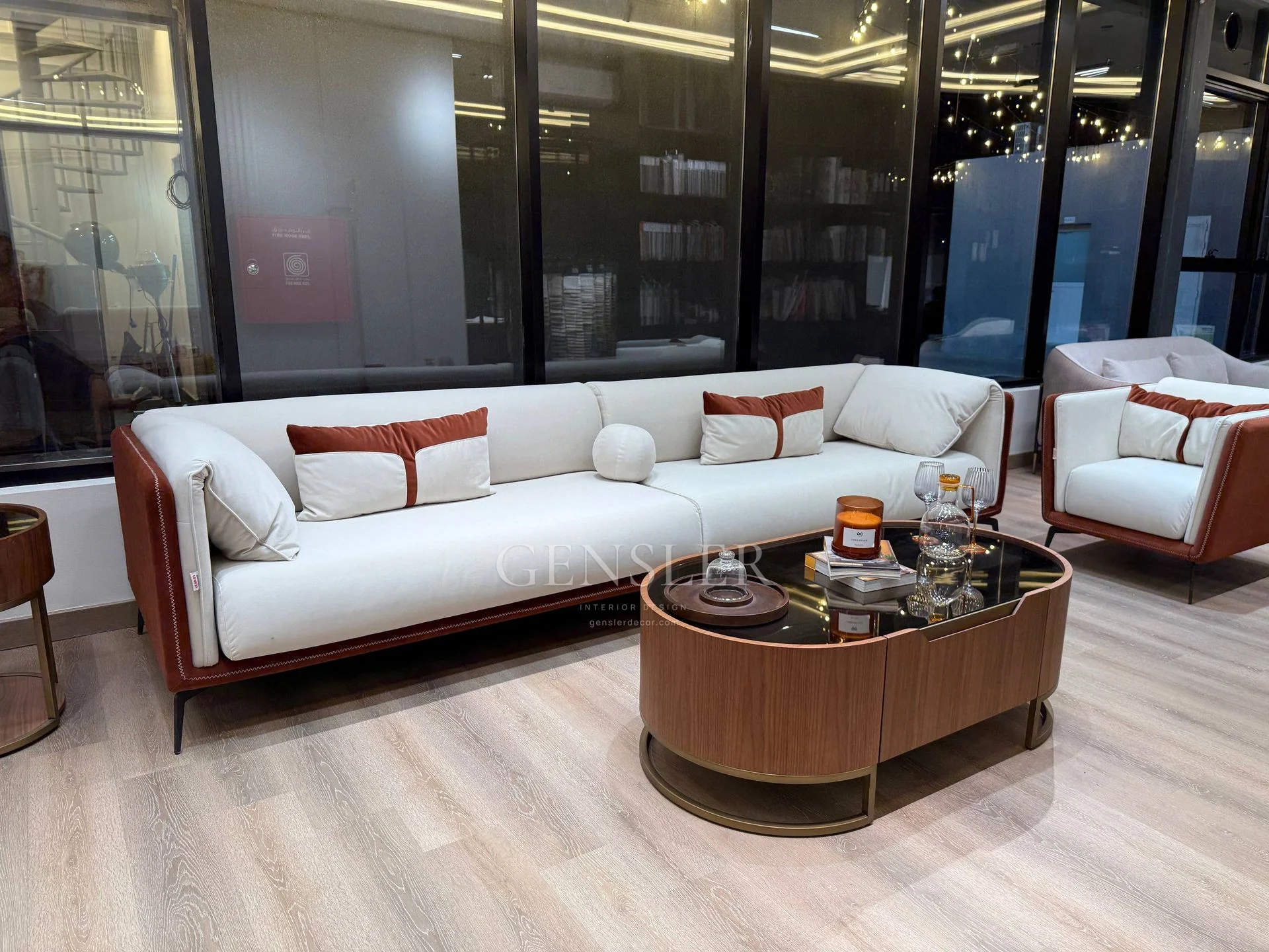 Ivory and brown sofa set with an oval dark-top coffee table.