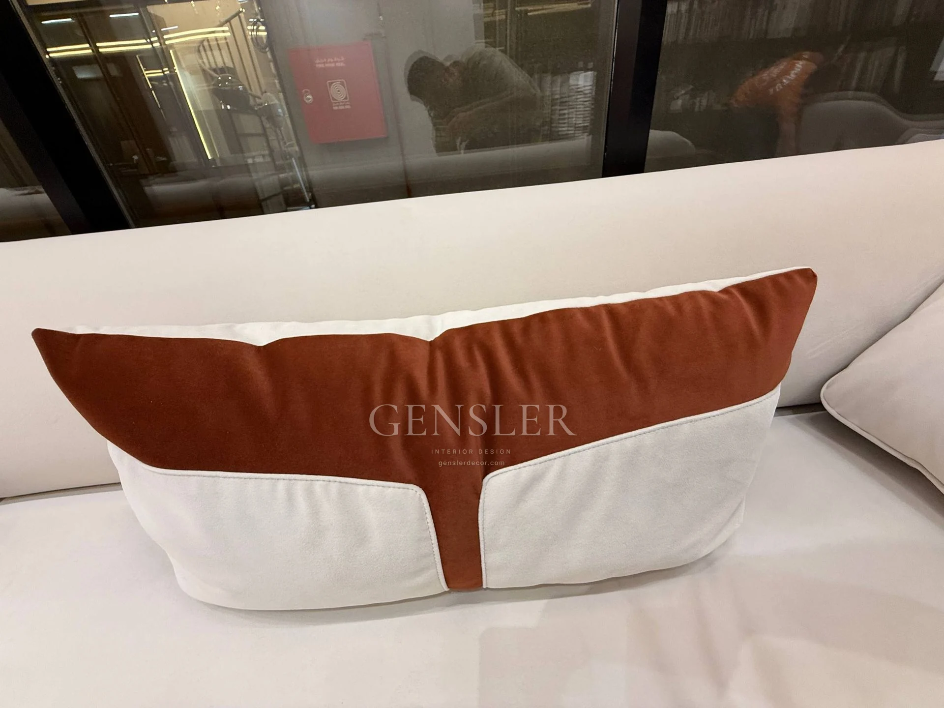 Two-tone ivory and brown sofa cushion.