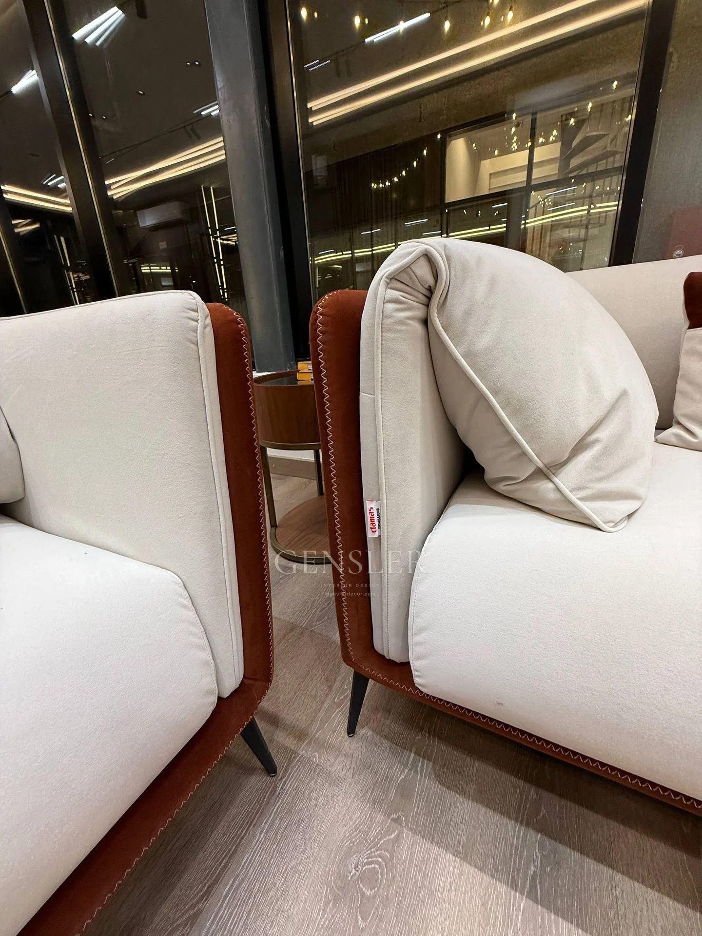 Close view of the upholstered sofa and armchair arms.